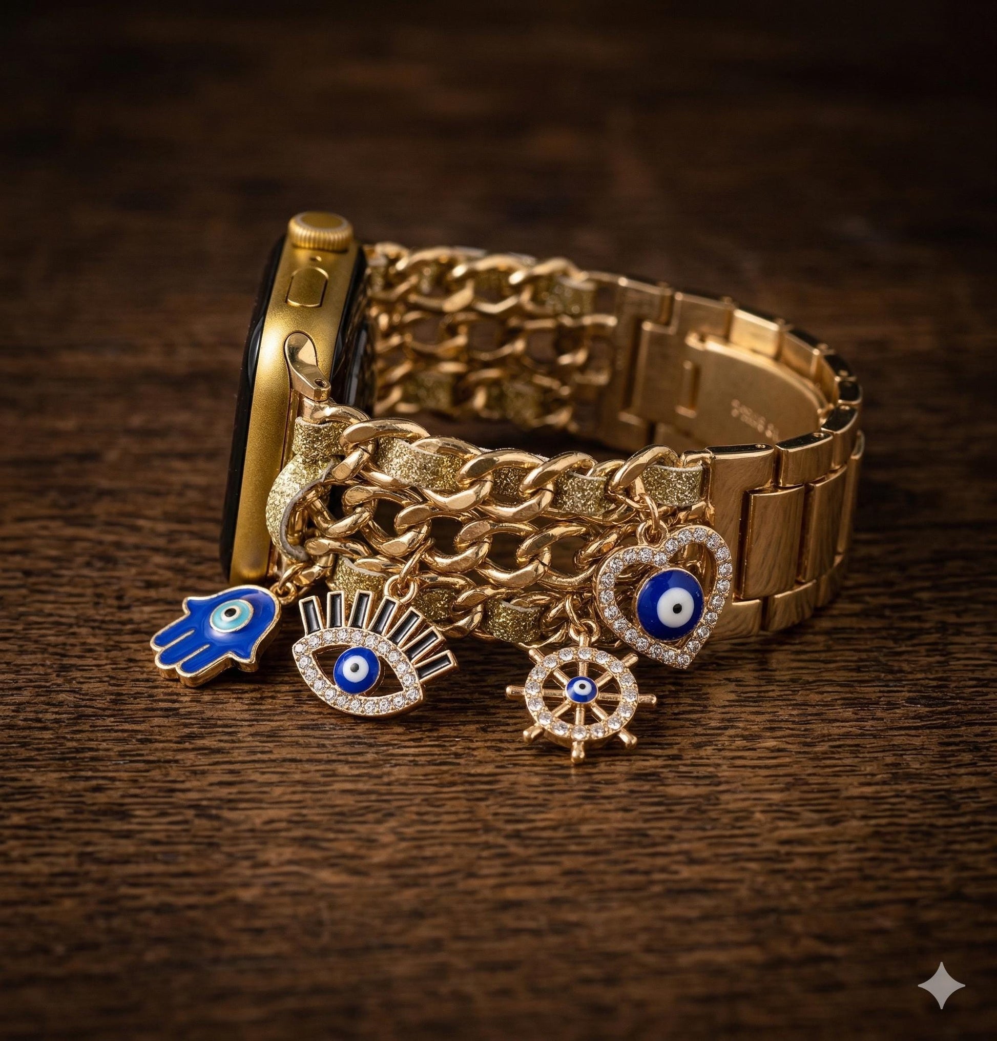 May include: Gold Apple Watch with a chain-style strap and hanging charms. The charms feature a blue hand, an eye, a heart, and a wheel, all with blue and white details. The watch is displayed on a dark wooden surface.